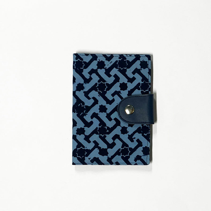A whitebox photo of passport cover in midnight arabesque showing out and frontside of the passport cover