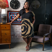 a woman in a batik dress in the pattern ecru rose, posing in a lifestyle photo