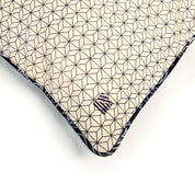 a batik cover with embroidered logo on a batik cover