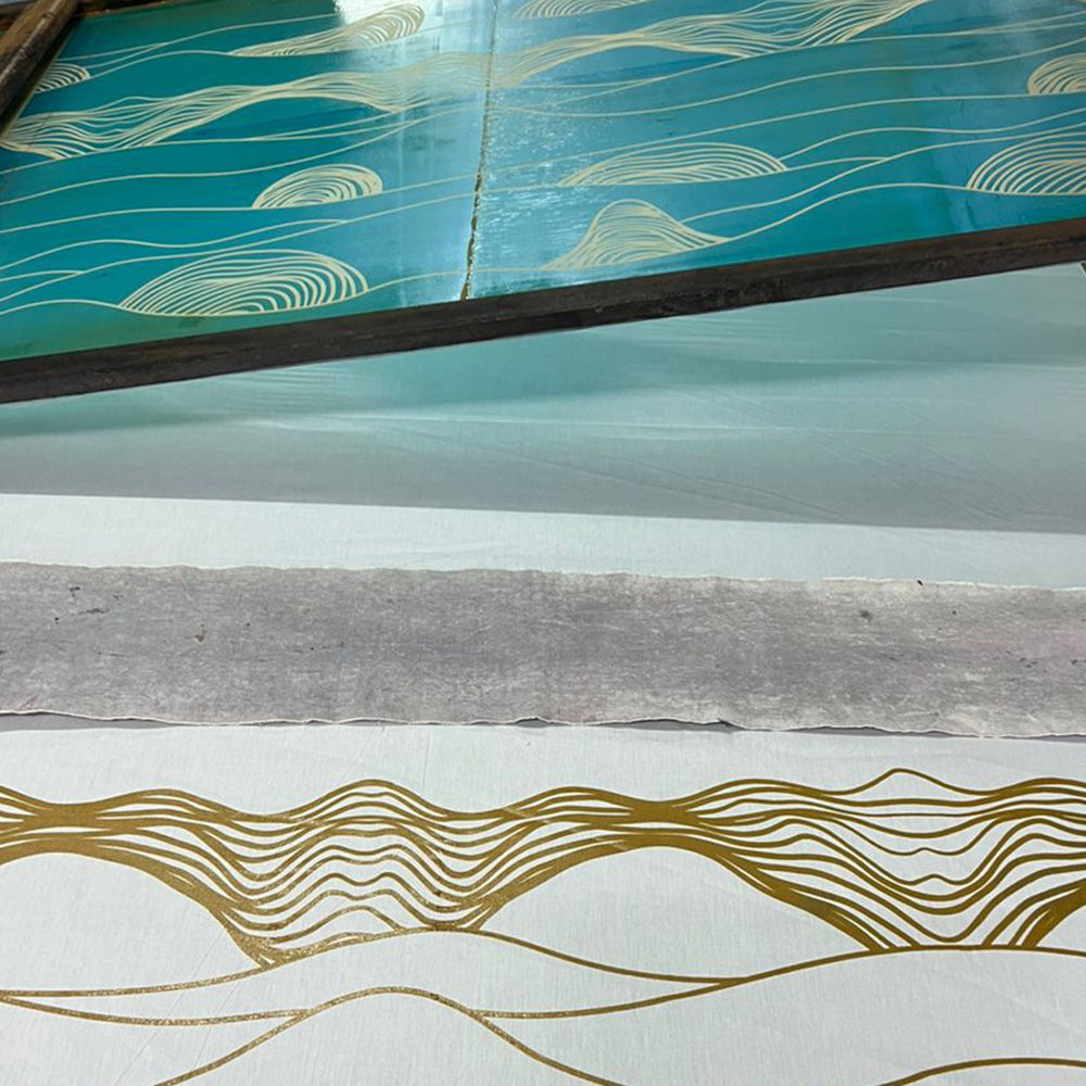 a photo of artisan doing batik in silkscreen technique