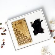 Batik Boutique Congkak Gift Set featuring bamboo congkak board with engraved floral batik motif and garnet firework batik pouch, presented in white gift box with gemstones decor,Handcrafted bamboo congkak board laser engraved with traditional batik flower pattern, paired with dark red batik drawstring pouch — Congkak Garnet Firework by Batik Boutique