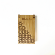 “Batik Boutique Congkak Gift Set featuring bamboo congkak board with engraved floral batik motif and garnet firework batik pouch, presented in white gift box with gemstones decor,Handcrafted bamboo congkak board laser engraved with traditional batik flower pattern, paired with dark red batik drawstring pouch — Congkak Garnet Firework by Batik Boutique