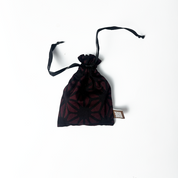 “Batik Boutique Congkak Gift Set featuring bamboo congkak board with engraved floral batik motif and garnet firework batik pouch, presented in white gift box with gemstones decor,Handcrafted bamboo congkak board laser engraved with traditional batik flower pattern, paired with dark red batik drawstring pouch — Congkak Garnet Firework by Batik Boutique