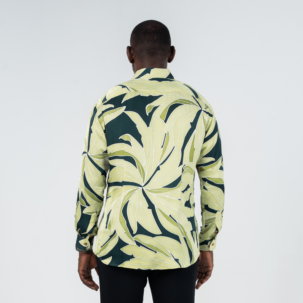 Back view of men's long-sleeved batik shirt in Forest Palma print, featuring bold tropical foliage motif in earthy green tones.