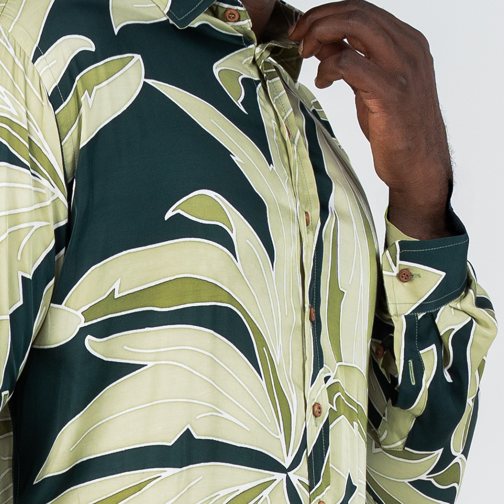 Closeup of Forest Palma batik shirt highlighting hand-painted leaf patterns and wooden buttons.