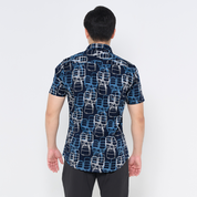 a male model showcasing the back of batik shirt in the pattern navy tiffin