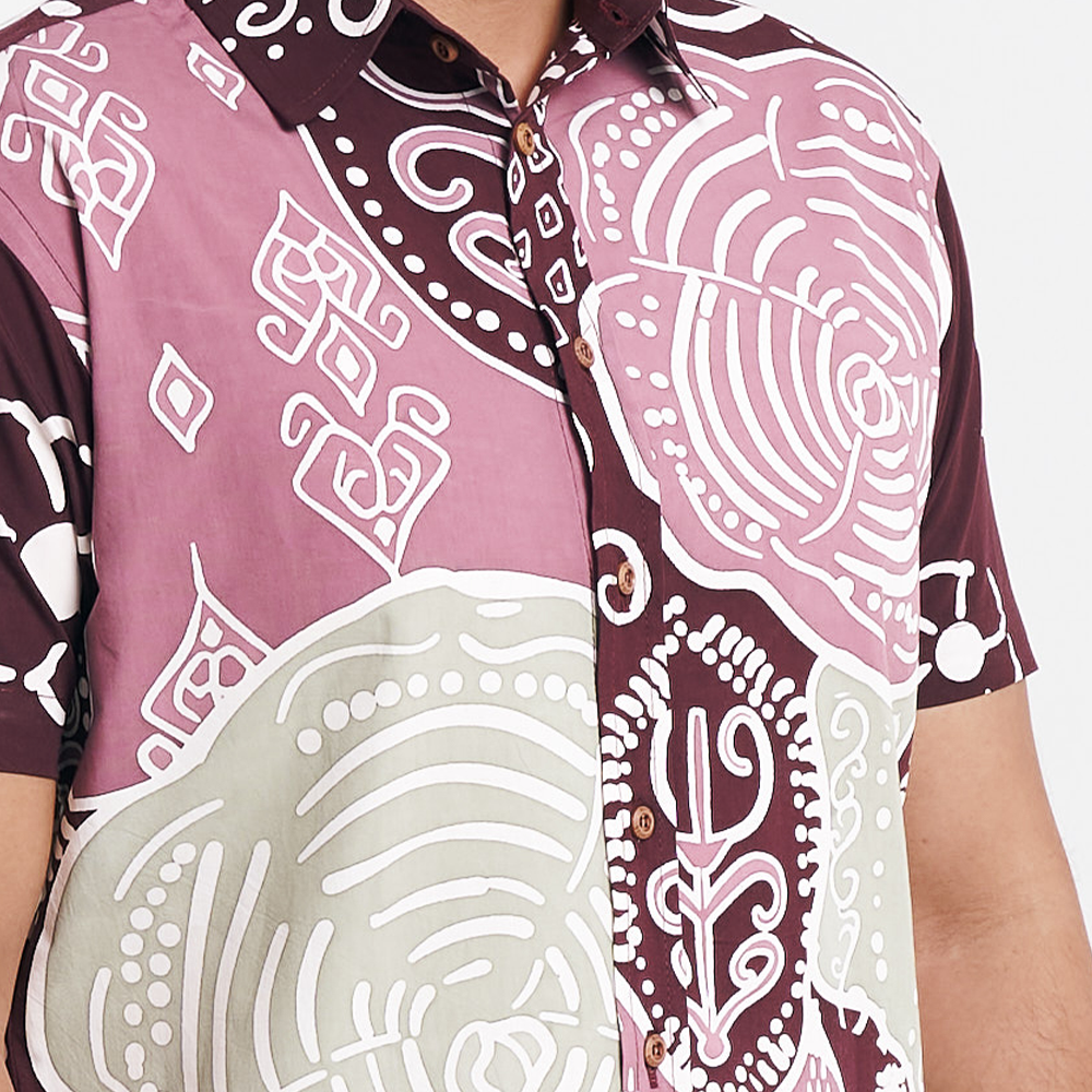 Close-up of the Maroon Petola batik shirt, showcasing intricate patterns and wooden buttons