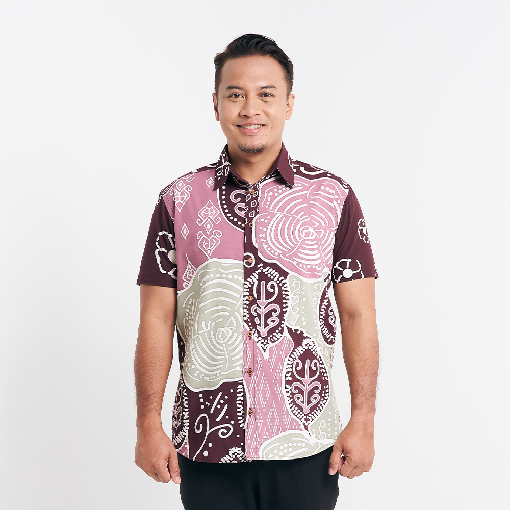 Man in a Maroon Petola batik shirt standing against a white background, displaying front details