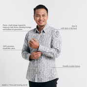Studio shot with text overlays highlighting the features of long sleeved batik shirt
