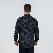 Back view of men's long-sleeved batik shirt in Jet Alur print, black with modern geometric batik motif.