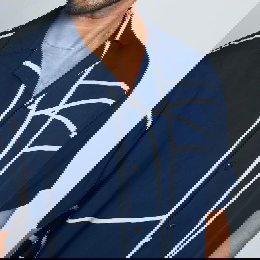 a closeup of batik shirt in the pattern navy brush against a white background