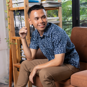a man wearing a batik shirt in the pattern navy kompas