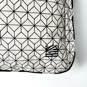 a closeup of batik pillow cover in black coconut against a white background