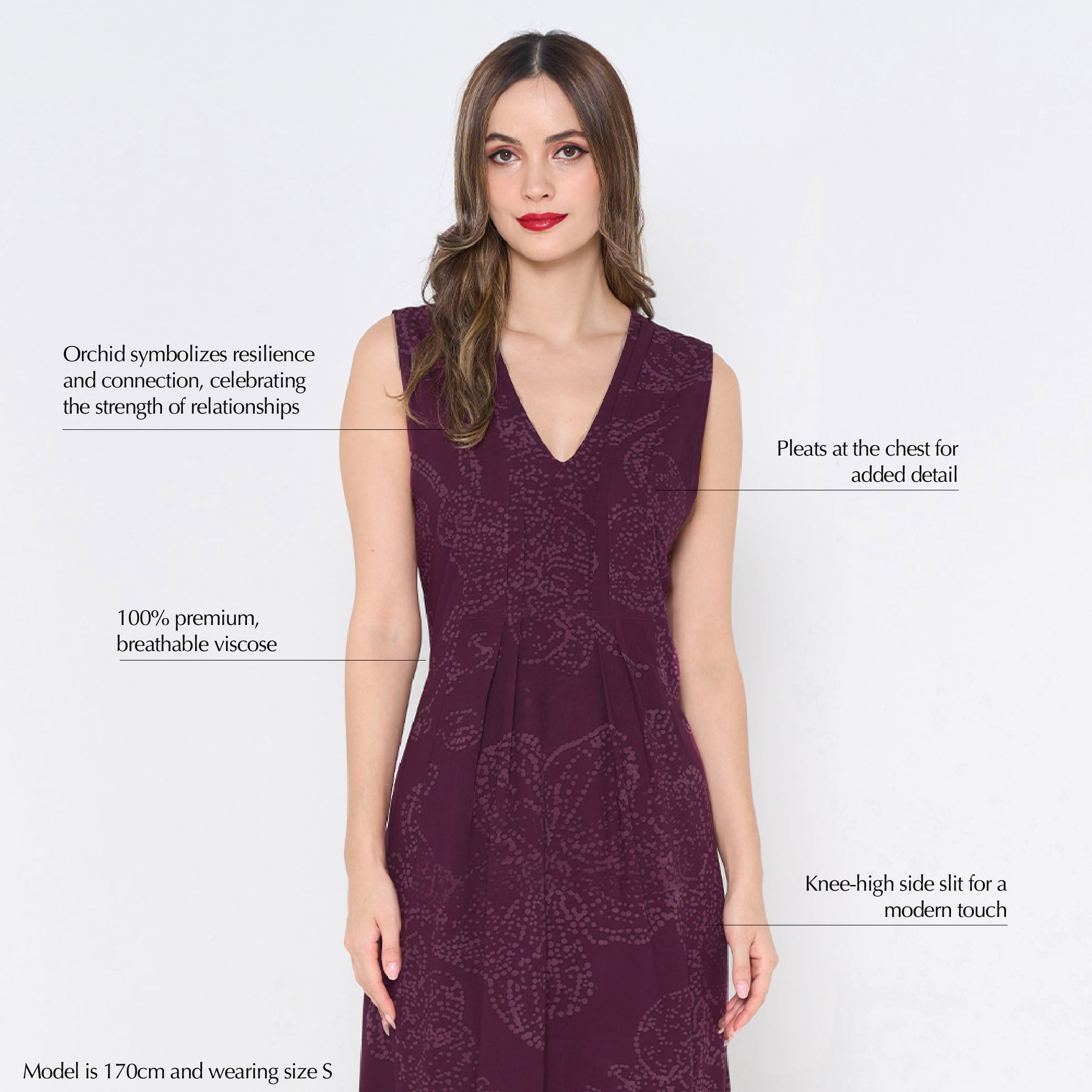 a woman wearing a batik dress against a white background in the pattern plum orchid
