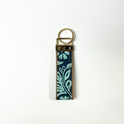the back of a key fob in the pattern teal ukir