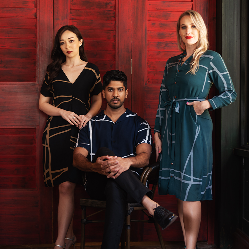 two woman and one man in batik sustainable clothing