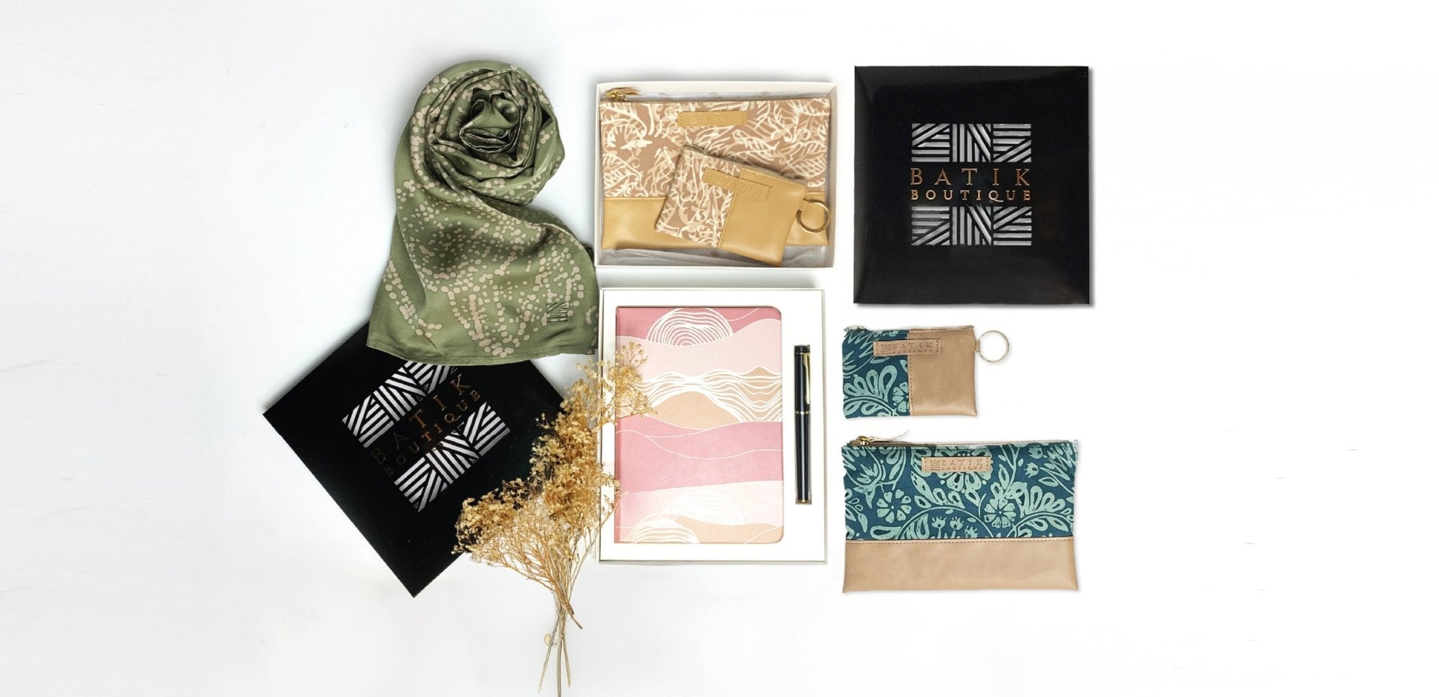 Batik Boutique women’s gift sets featuring batik scarf in Moss Orchid with gift box, Tan Nautical Fern organizer pouch, Dawn Bukit notebook with pen, and Teal Ukir pouch set. Ideal for corporate gifting or special occasions.