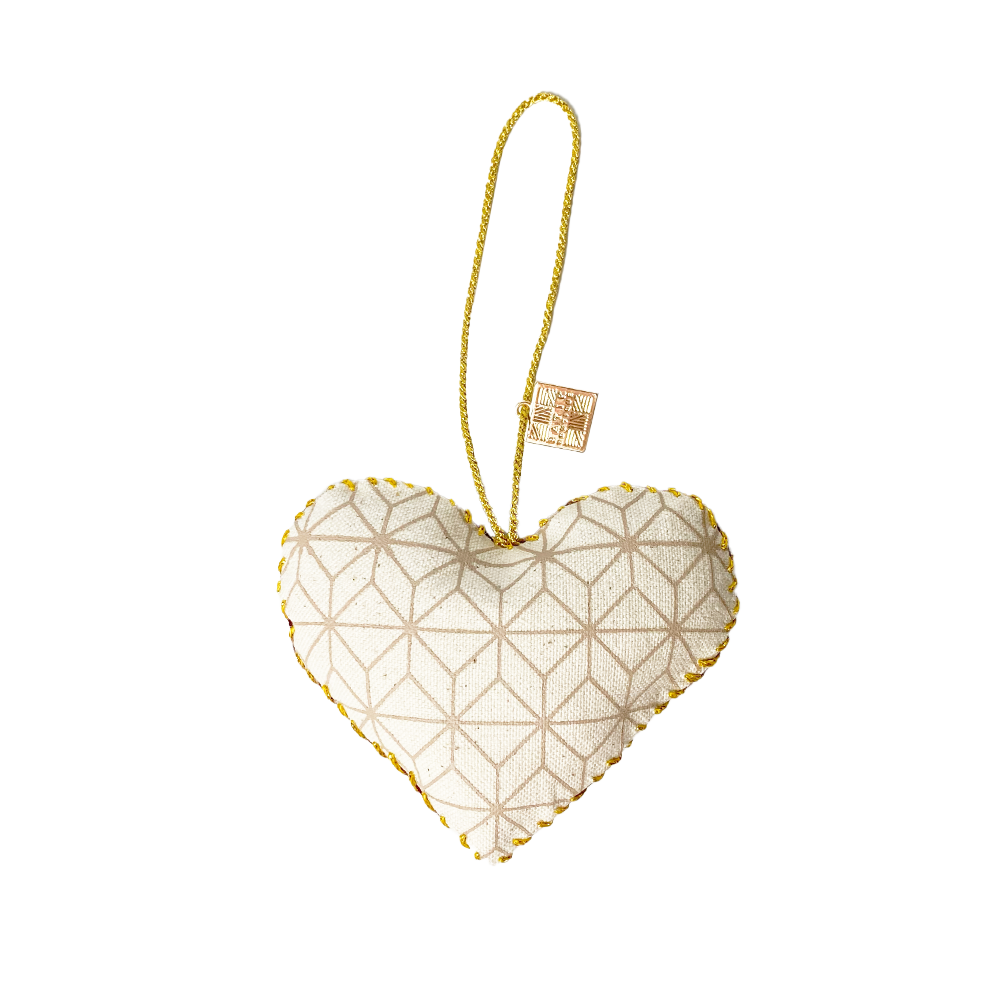 A whitebox photo of handmade heart ornaments in crimson celestial pattern showing backside of the ornaments