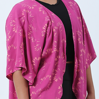 a close up shot of a cardigan kimono in the pattern fuchsia paws in front of a white background