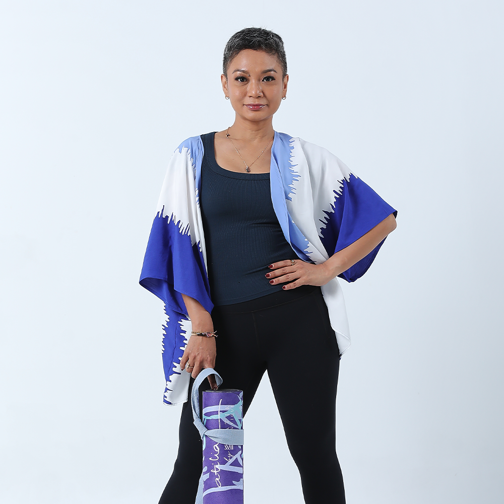 atilia posing against a white background in a batik shirt in the pattern ice fur