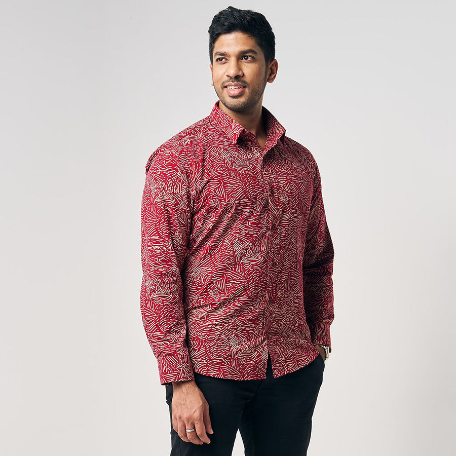 A model is wearing crimson red color long sleeve men shirt in crimson driftwood with white background