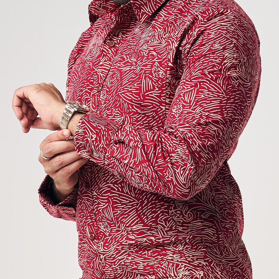 A close up photo of model wearing crimson red color long sleeve men shirt in crimson driftwood with white background