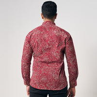 A model is wearing crimson red color long sleeve men shirt in crimson driftwood with white background showing backside of the shirt