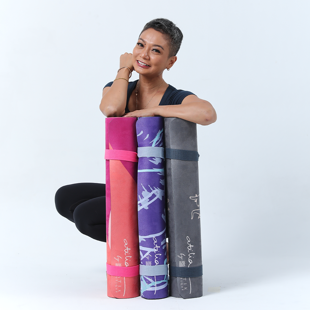 a model posing with 3 yoga mats