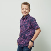 A boy wearing batik shirt in purple bintik pattern