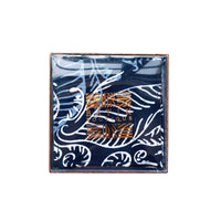 batik coasters being showcased inside of the box with a transparent lid, against a neutral background in the pattern blue nautical fern