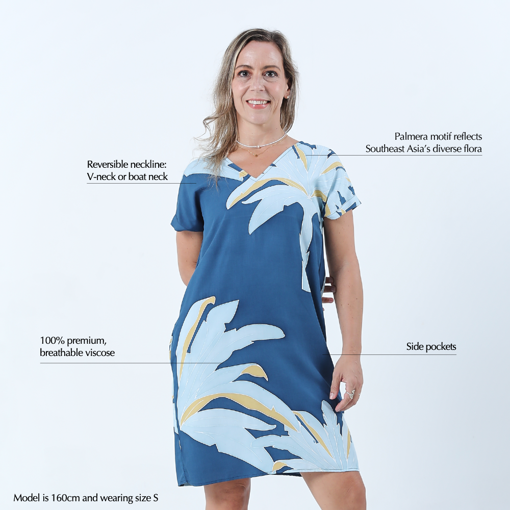 a woman wearing a batik dress against a white background in the pattern ocean palmera