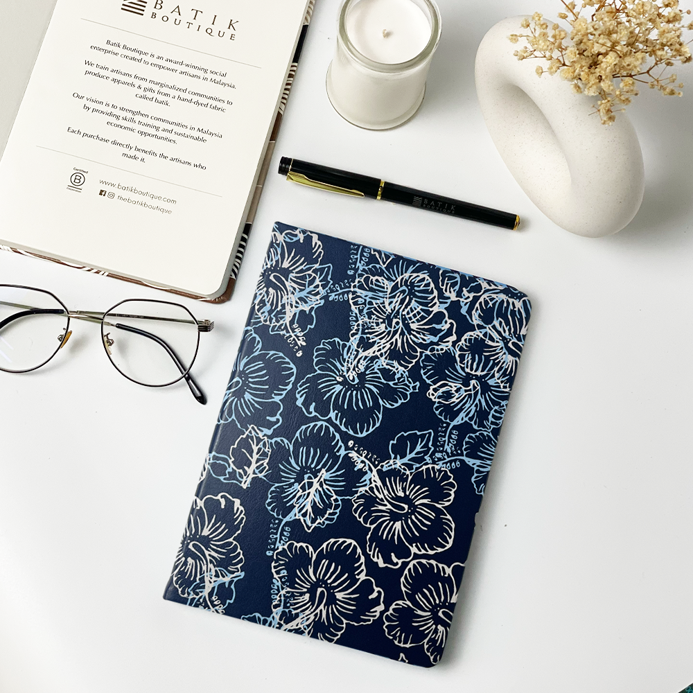 batik inspired notebook in a lifestyle photo in the pattern navy hibiscus