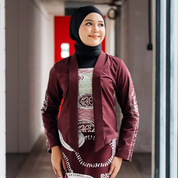 Maroon Petola Batik Kebaya Jacket – A model wearing a handcrafted maroon batik kebaya jacket with elegant detailing