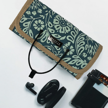 Teal Ukir Batik Roll Up Travel Pouch in a lifestyle photo made of authentic batik