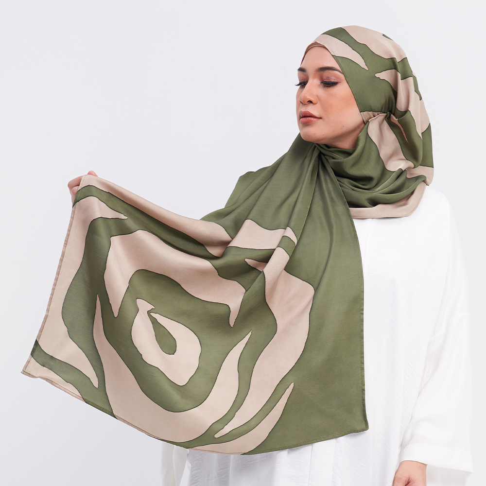 a woman posing with olive rose batik scarf against a white background