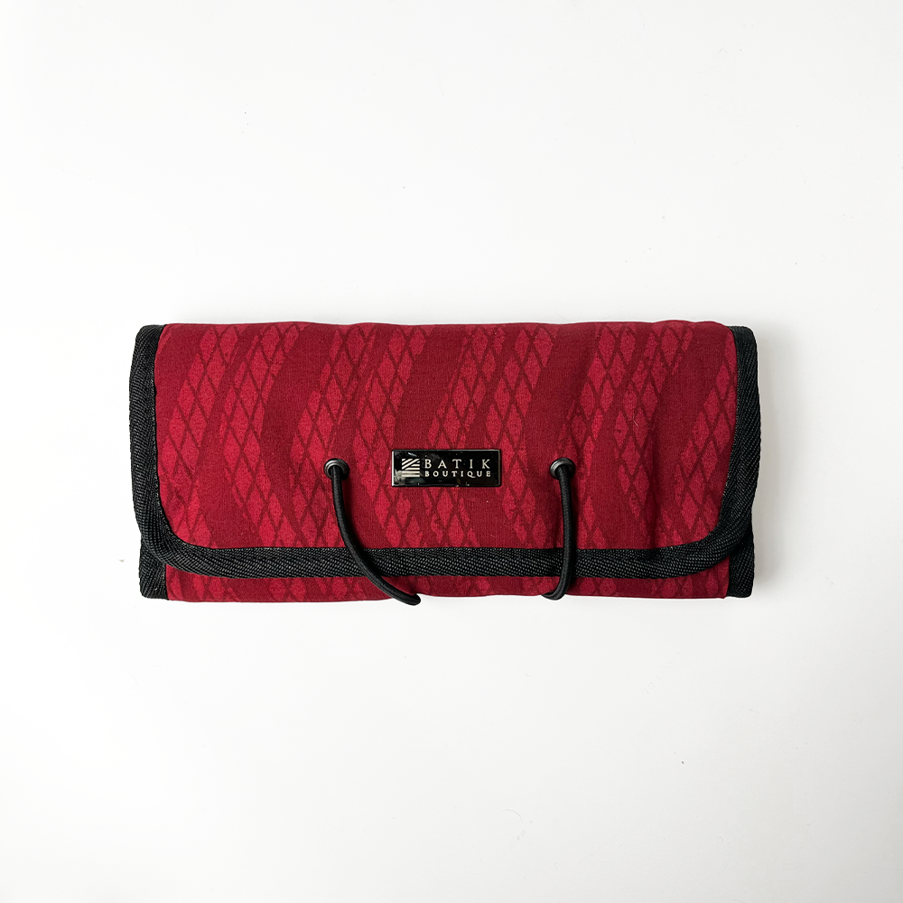 Handcrafted Batik Travel Roll Up Pouch in red snakeskin pattern, versatile and stylish for on-the-go organization.
