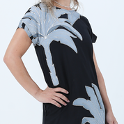 a batik dress against a white background in the pattern midnight palmera closeup