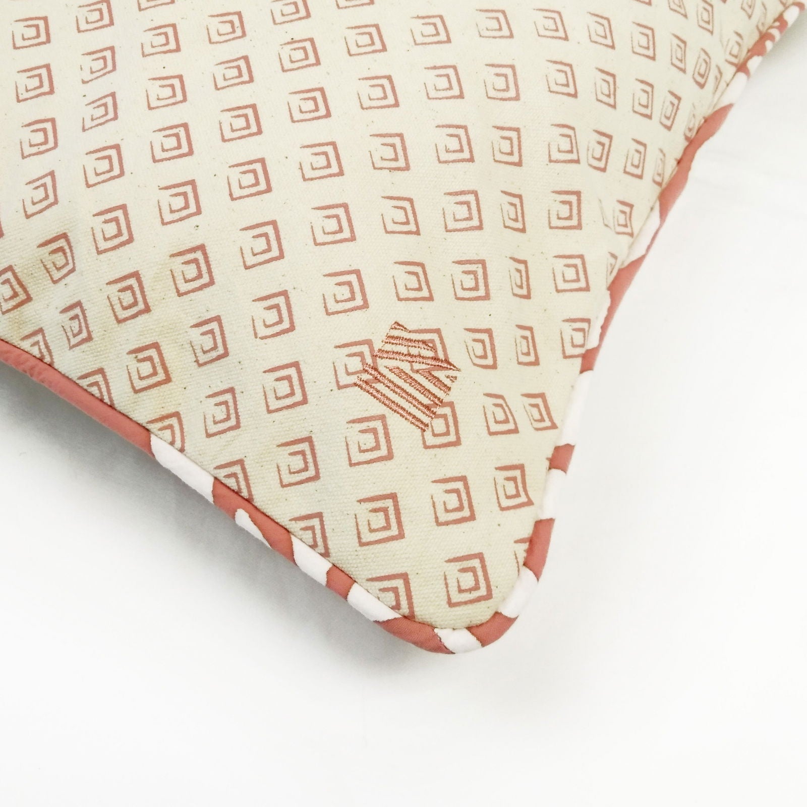 a reversible batik pillow against a white background in the pattern coral bunga