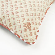 a reversible batik pillow against a white background in the pattern coral bunga