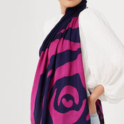 a close up of a batik scarf in the pattern fuchsia rose against a white background