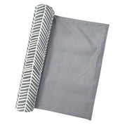 a batik table runner on a white background in the pattern grey banana leaf rolled up