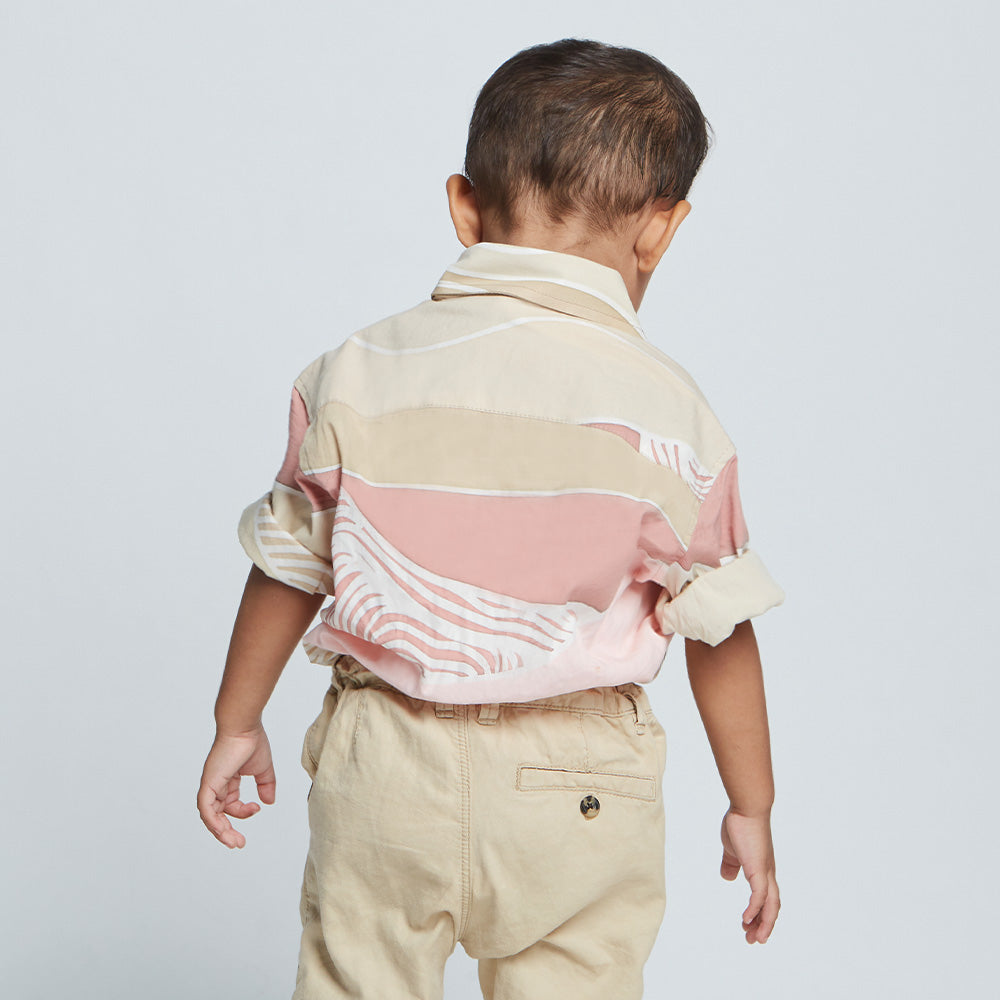 Batik view of young boy wearing pink batik mshort sleeve shirt from Batik Boutique.