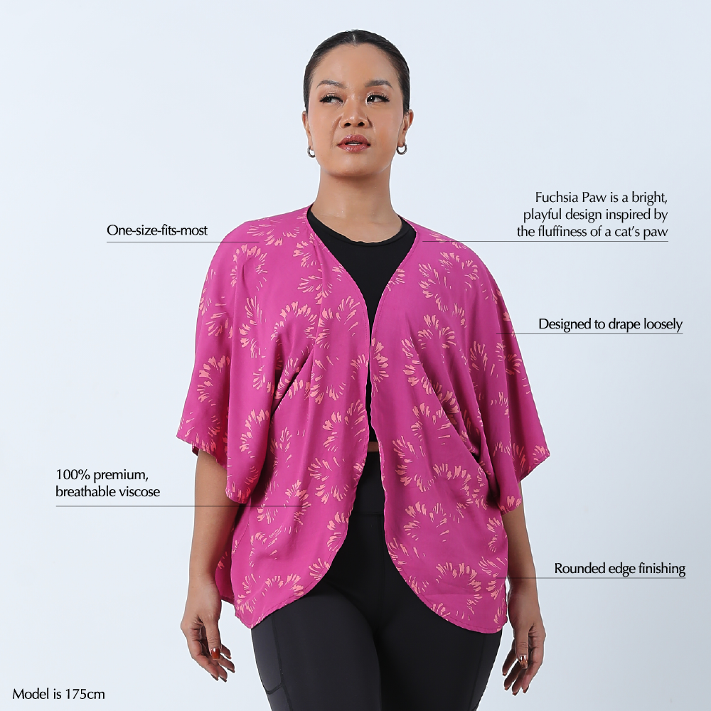 a woman wearing a cardigan kimono against a white background in the pattern fuchsia paw