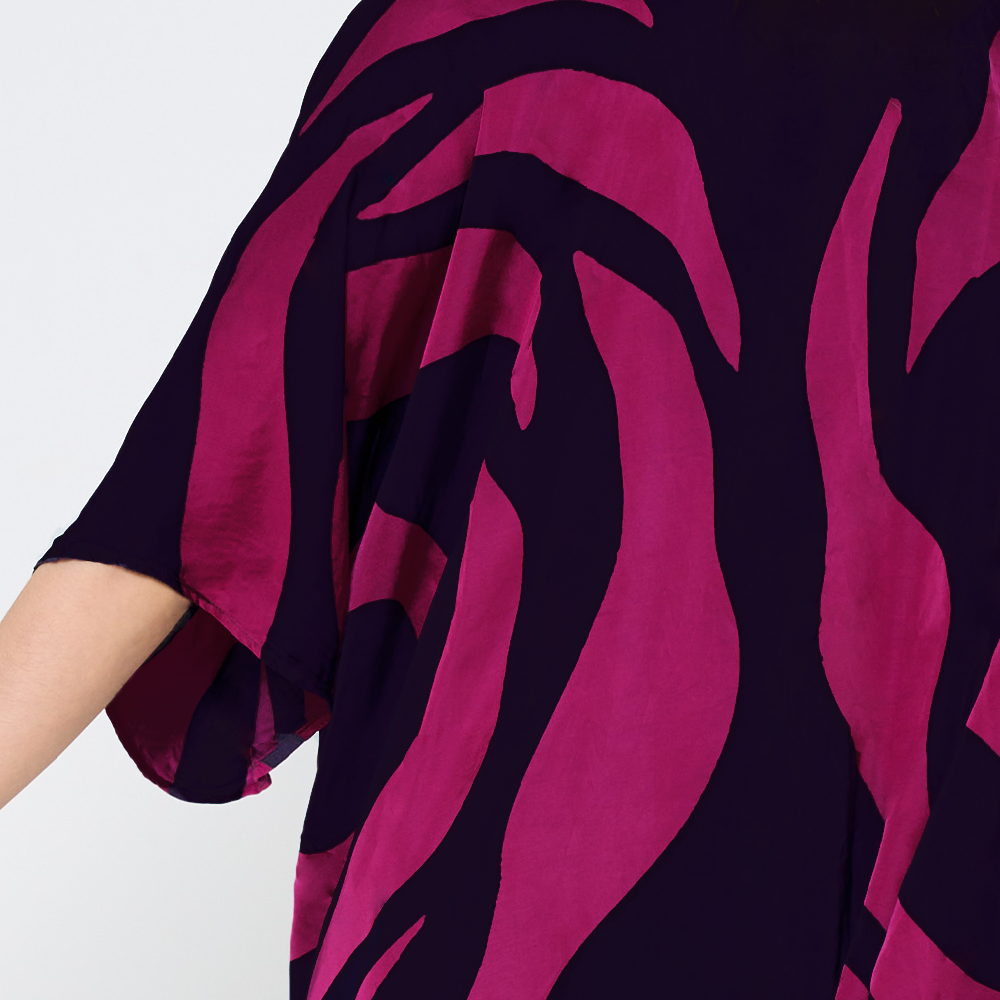 a closeup shot of batik kimono in the pattern fuchsia rose against a white background