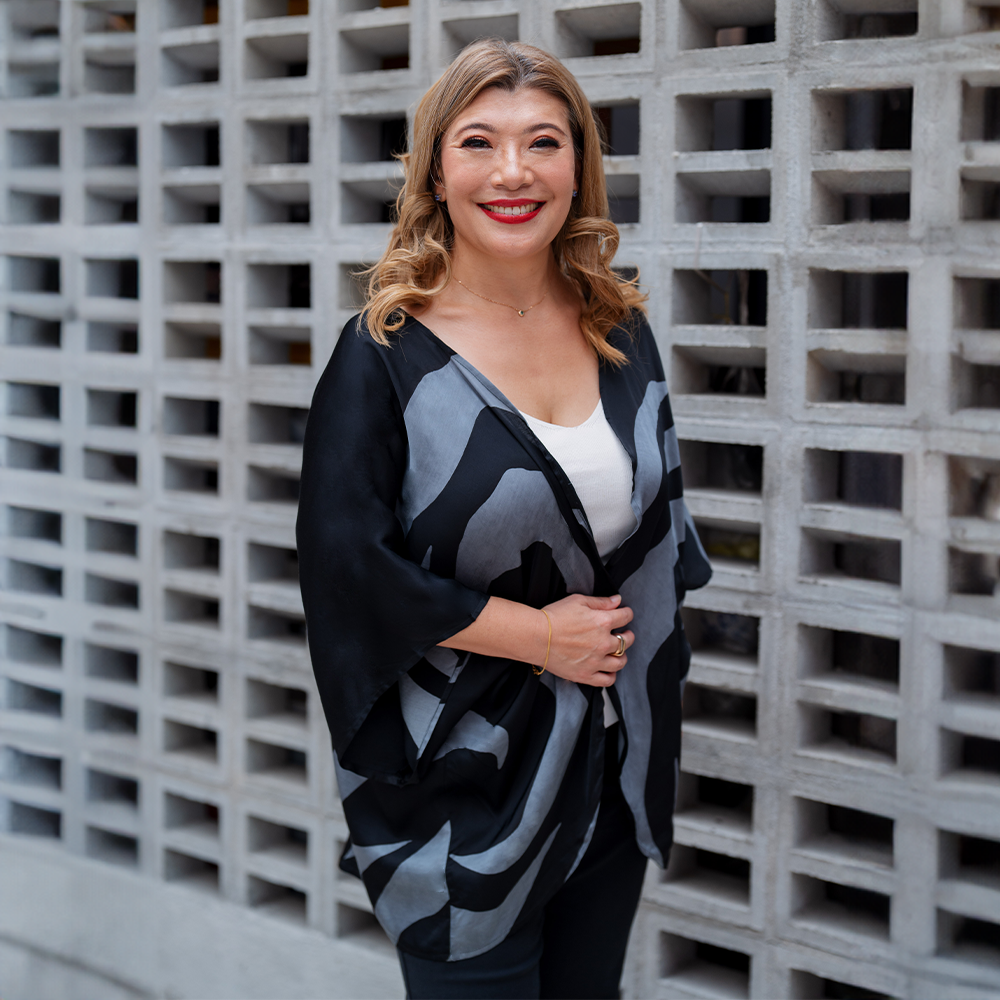 a woman dressed in batik cardigan kimono in the pattern grey rose in a lifestyle photo