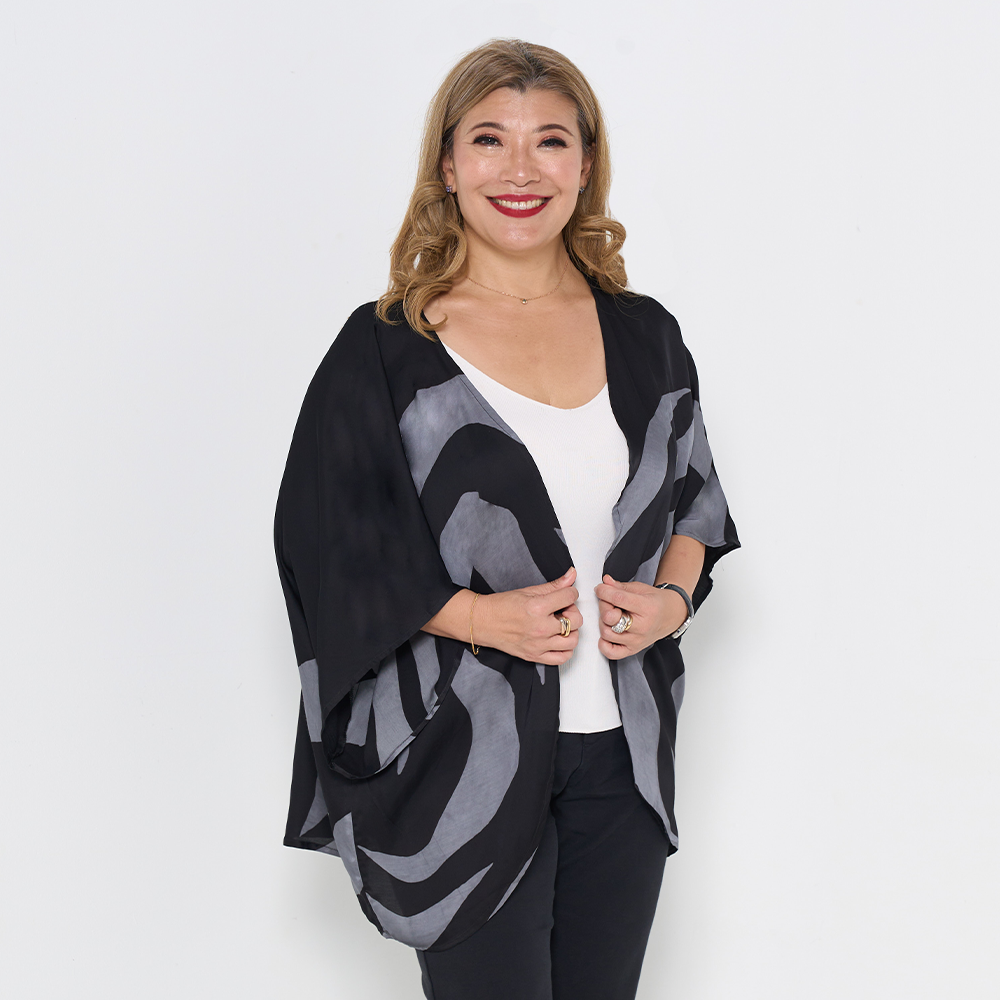 a model against a white background wearing an authentic batik cardigan kimono in the pattern grey rose