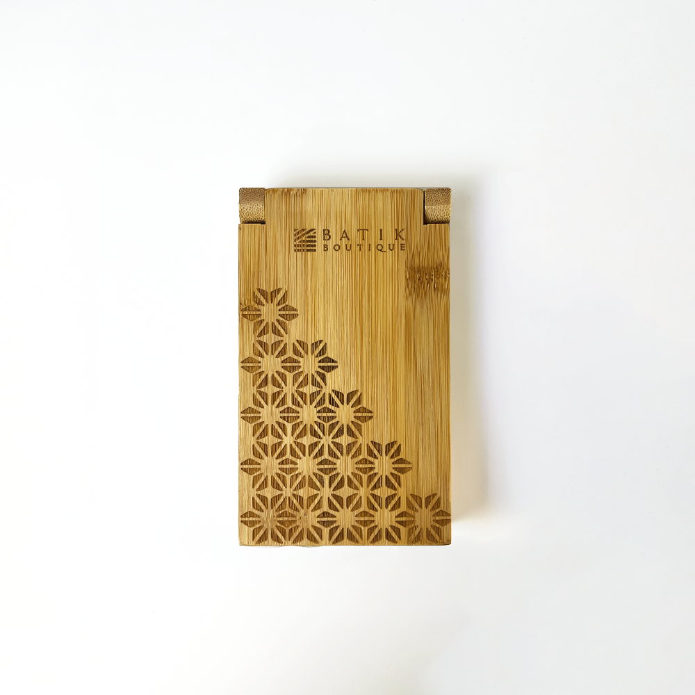 a laser engraved congkak board against a white background in the batik inspired pattern firework