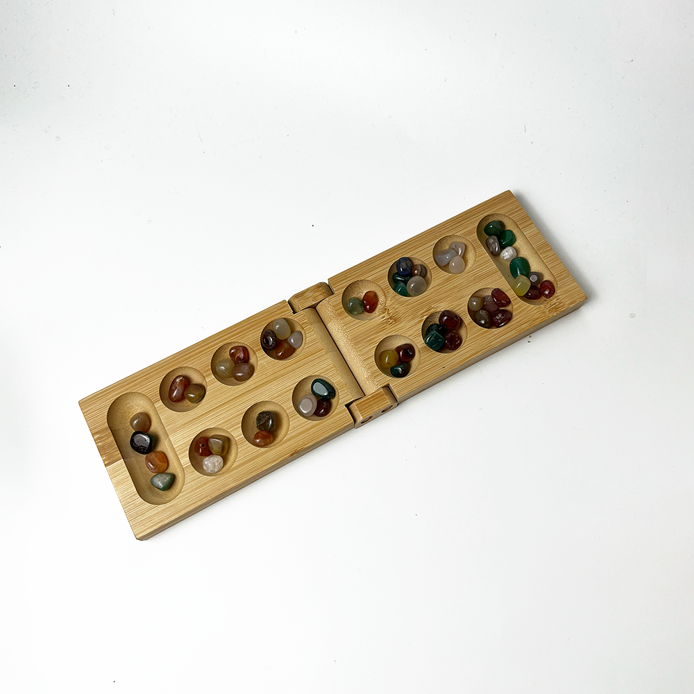 a congkak board against a white background