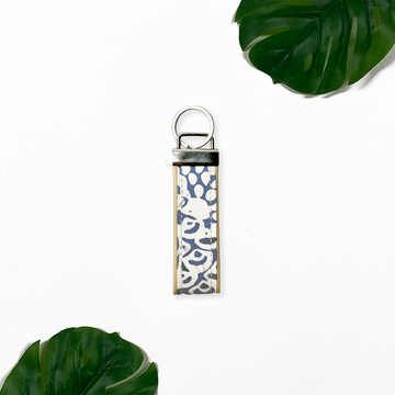 a lifestyle image of a key fob made of batik in the pattern grey peony