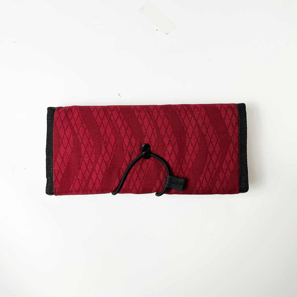 Red snakeskin travel pouch with a sleek and functional design, perfect for keeping your items safe while traveling.